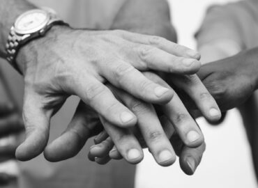 Team of business people stacking hands